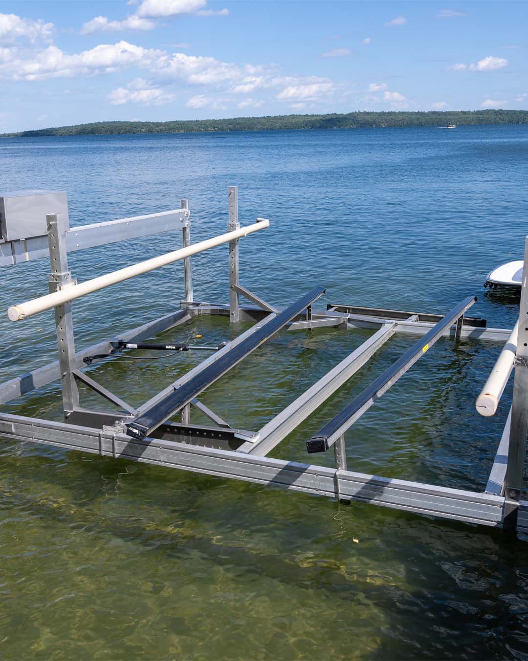 AutoLift horizontal boat lift installed on a dock, showing the expandable arm mechanism